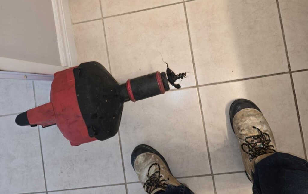 Professional pipe joint inspection during a Drain Cleaning local service by Superior Plumbing & Heating.