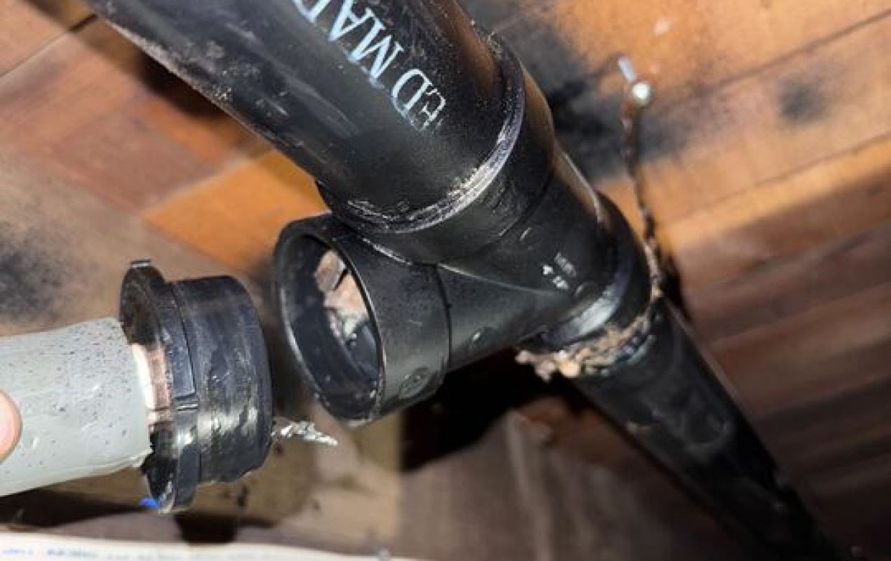 Disconnected black ABS pipes inspected for Drain Cleaning local by Superior Plumbing & Heating experts.
