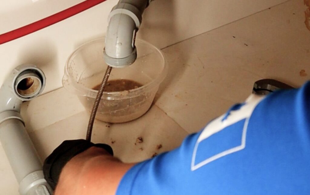 Dirty wastewater draining during professional Drain Cleaning local by Superior Plumbing & Heating.