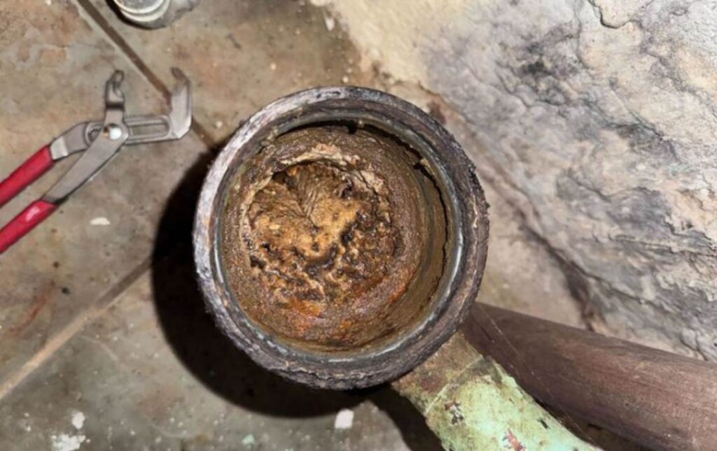 Severe rust in a drain line before Drain Cleaning local by Superior Plumbing & Heating.