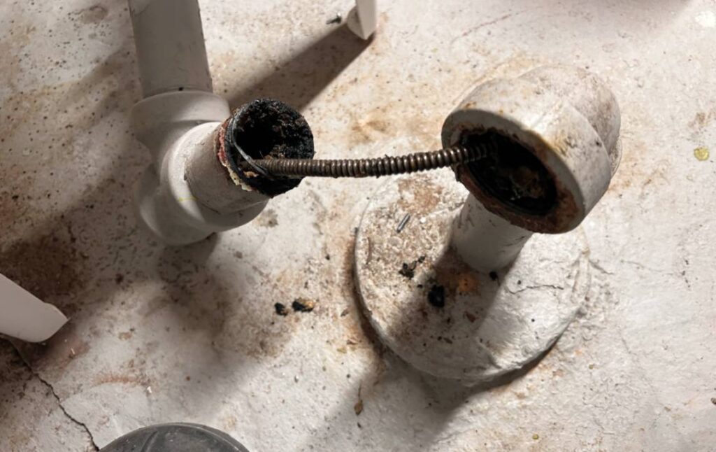 Close-up of a drain snake in action for Drain Cleaning local by Superior Plumbing & Heating.