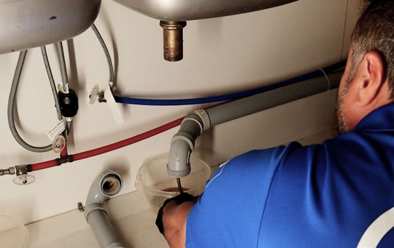 Superior Plumbing & Heating specialist fixing a clogged drain for Drain Cleaning local projects.