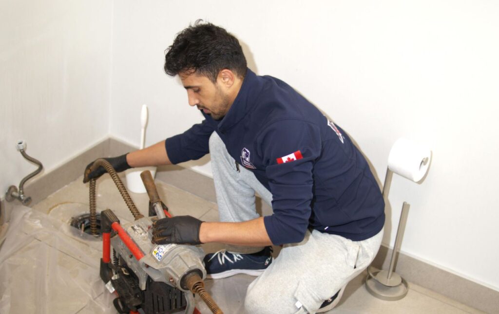 Superior Plumbing & Heating pro operating a machine for a Drain Cleaning local project.