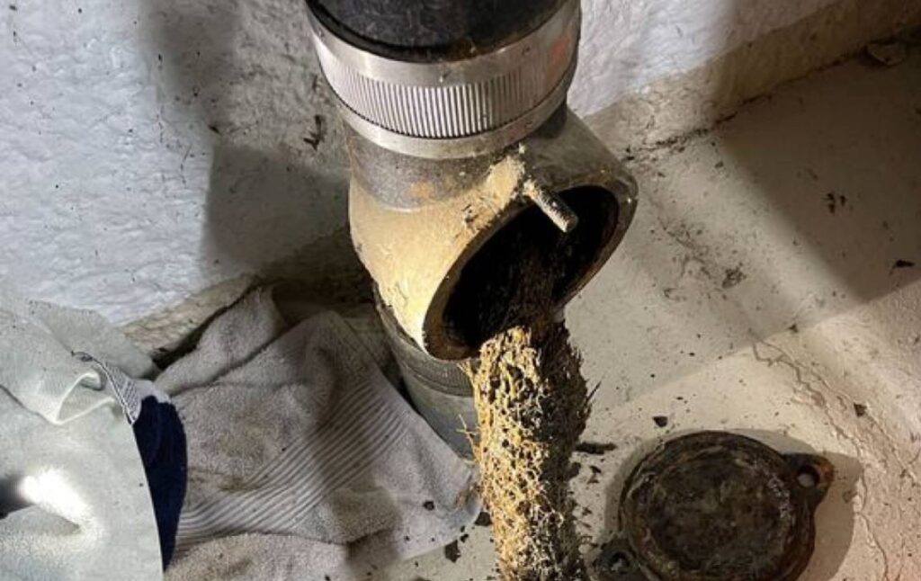 Heavy sludge buildup cleared during Drain Cleaning local by Superior Plumbing & Heating.