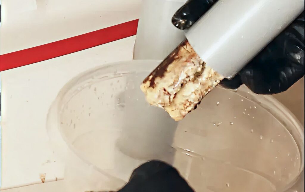 Calcified pipe debris removed during a Drain Cleaning local service by Superior Plumbing & Heating.