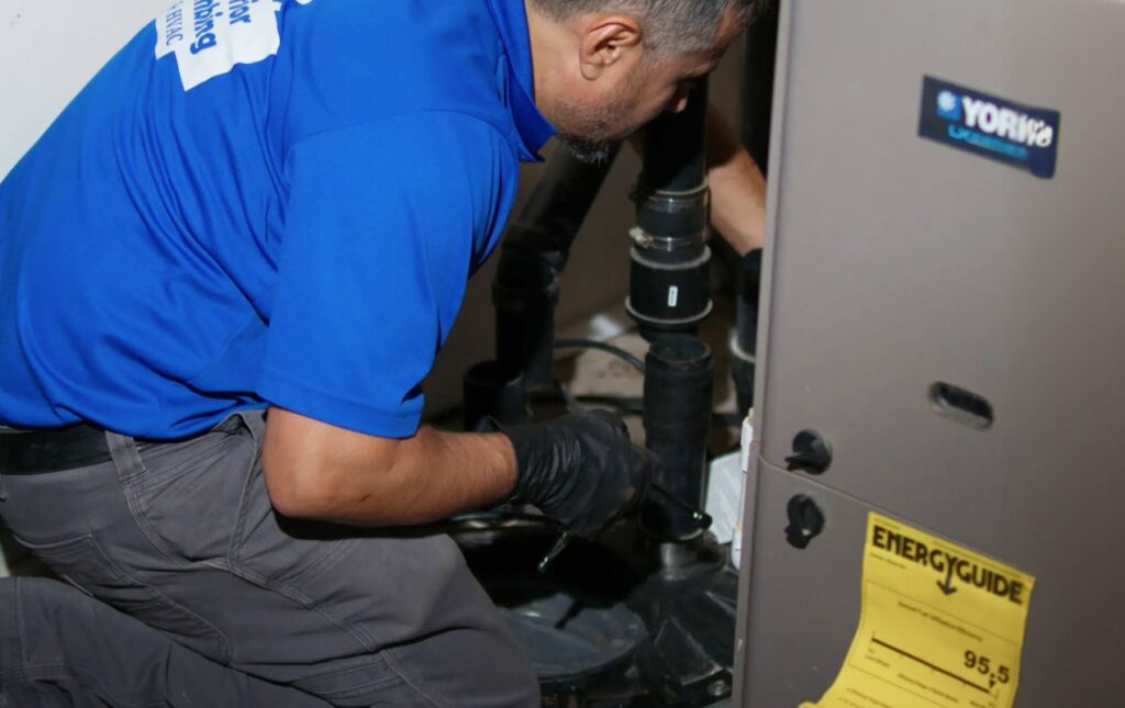 Superior Plumbing & Heating specialist inspecting a basement system during a Sump pump repair local call