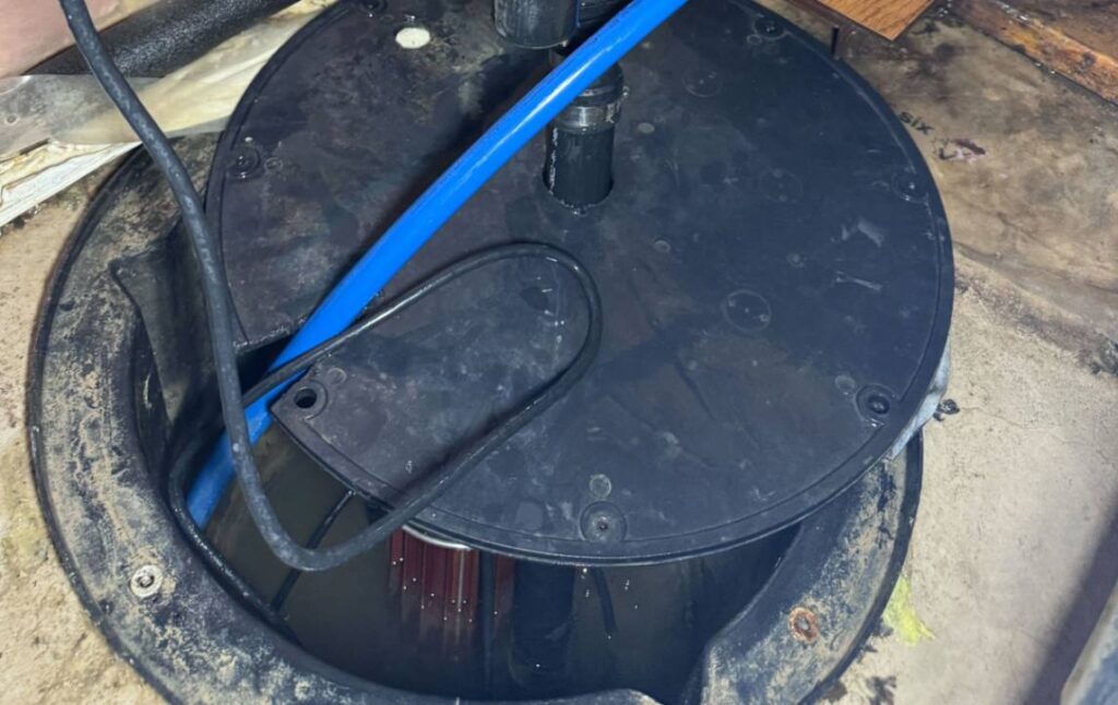 Open sump pump basin with pipes ready for a Sump pump repair local service by Superior Plumbing & Heating