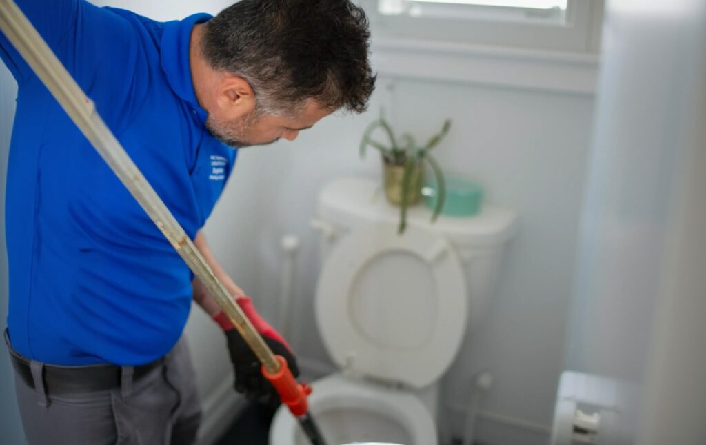 Toilet repair service by Superior Plumbing & Heating clearing a toilet drain and restoring smooth, reliable bathroom operation