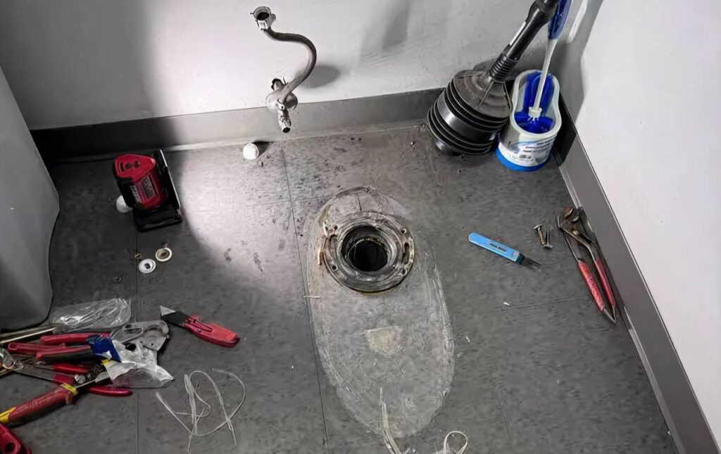 Toilet repair service by Superior Plumbing & Heating repairing a toilet flange and drain opening before proper toilet installation