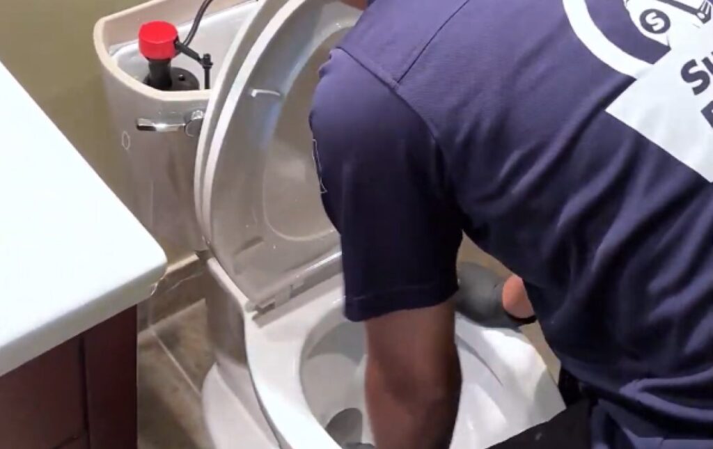 Professional clogged toilet repair by Superior Plumbing & Heating, unclogging the toilet and restoring proper drainage