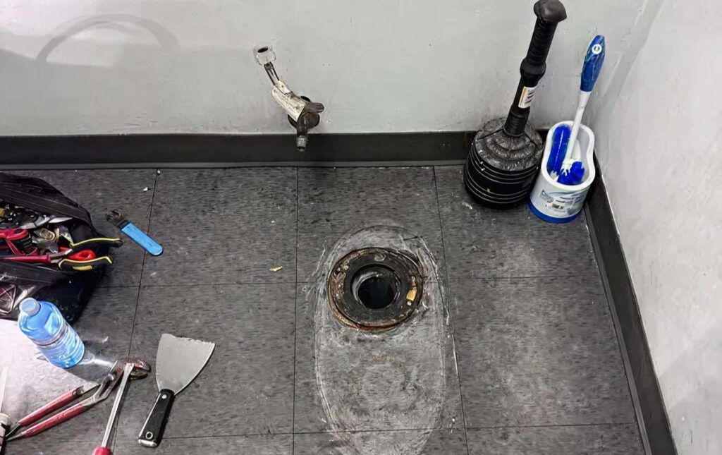 Toilet repair service by Superior Plumbing & Heating fixing a damaged toilet flange and preparing the base for proper installation