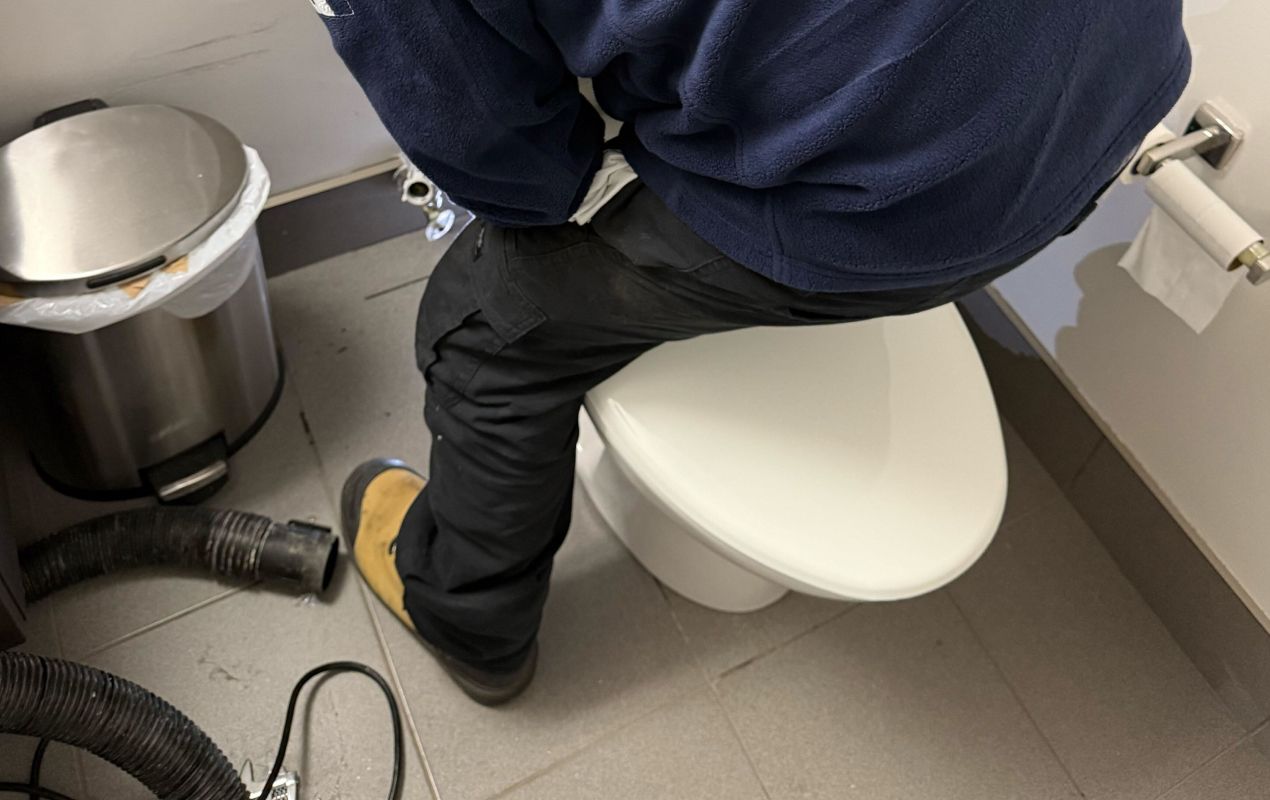 Toilet repair service by Superior Plumbing & Heating securing the toilet base and restoring stable, safe bathroom use