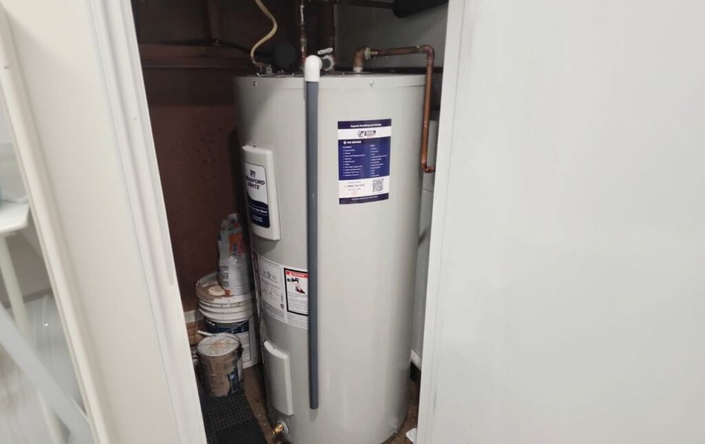 Superior Plumbing & Heating expert installing a high-capacity tank water heater with expansion tank and code-compliant plumbing connections