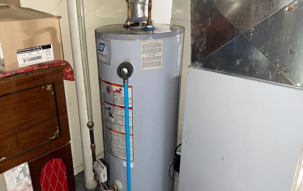 Superior Plumbing & Heating expert Water Heater Repair of a John Wood grey gas tank in a residential basement