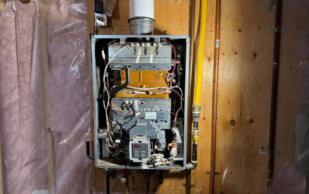 Superior Plumbing & Heating expert Water Heater Repair of a gas tankless unit with exposed internal components