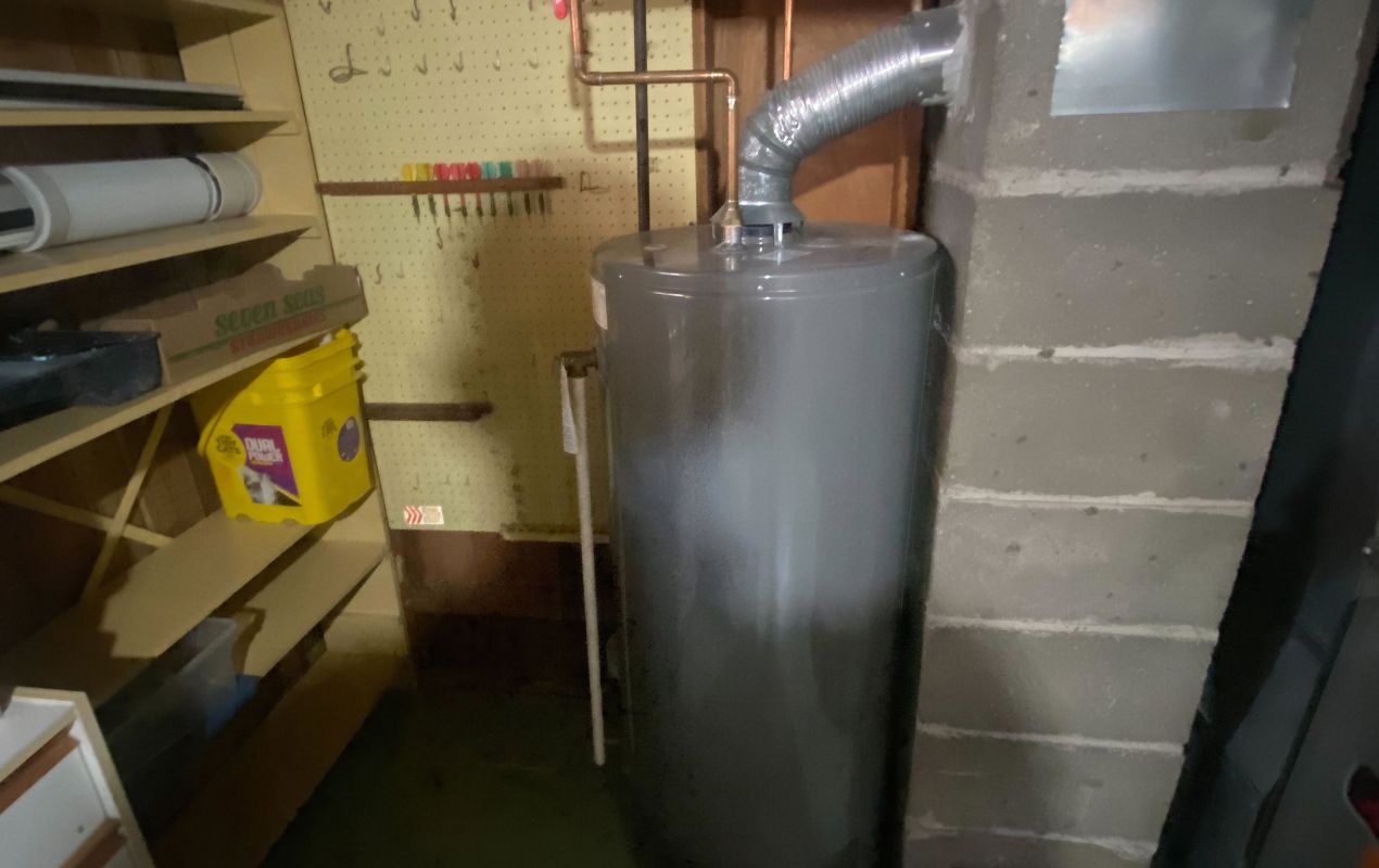 Superior Plumbing & Heating professional Water Heater Installation of a gas tank unit in a residential basement setting
