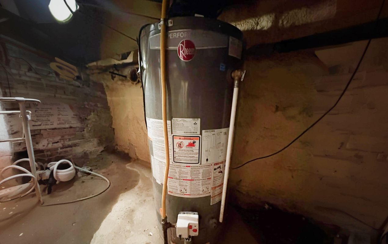 Superior Plumbing & Heating professional Water Heater Installation of a Rheem gas tank in a home basement setting
