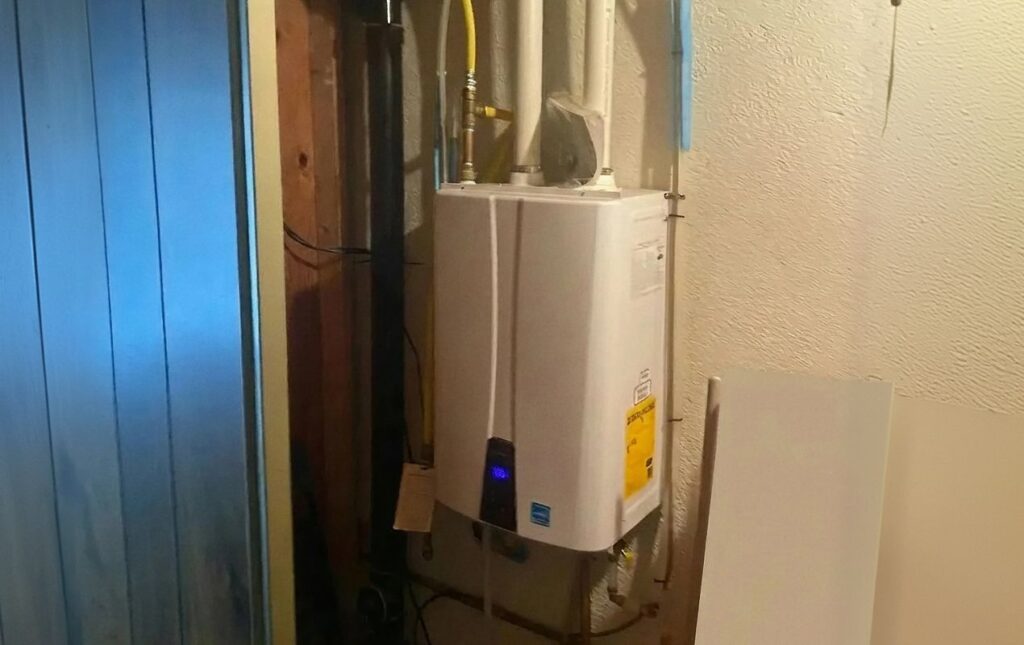 Superior Plumbing & Heating professional Water Heater Installation of a wall mounted tankless gas unit in a basement