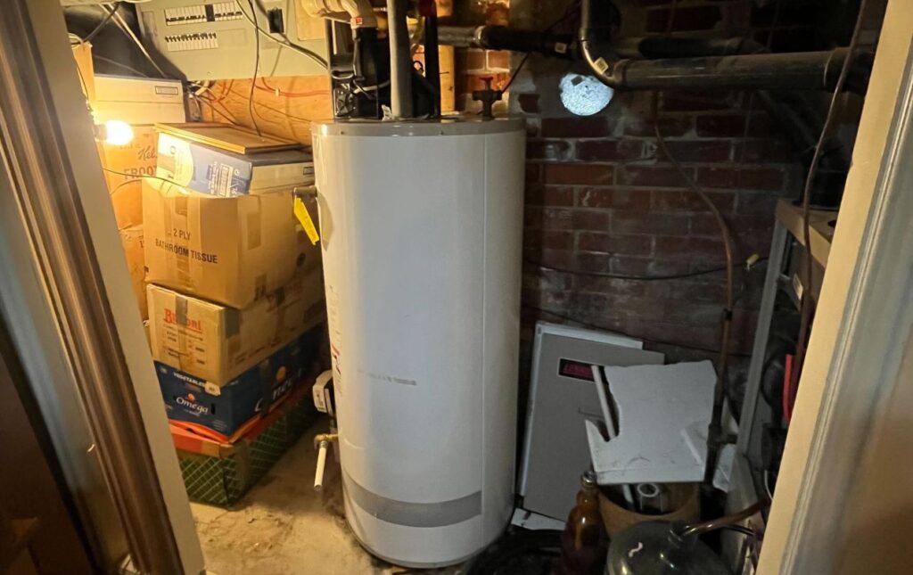 Superior Plumbing & Heating professional Water Heater Installation of a white storage tank in a residential basement
