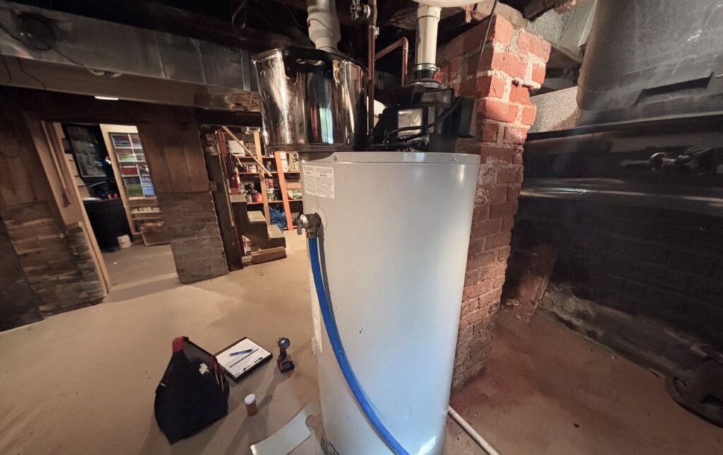 Superior Plumbing & Heating professional Water Heater Installation for a residential basement unit with service tools