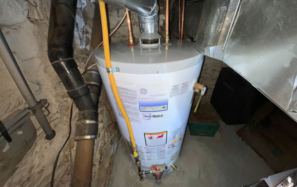 Superior Plumbing & Heating professional Water Heater Installation of a white gas tank in a home basement