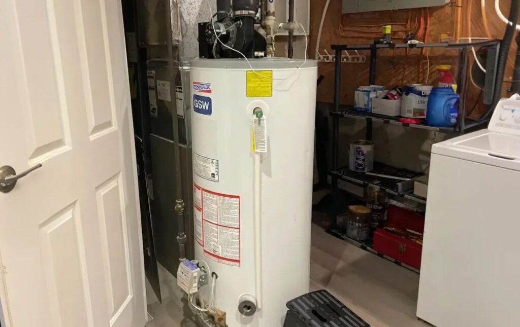 Superior Plumbing & Heating technician installing a traditional gas water heater with code-compliant piping and ventilation in a home utility room