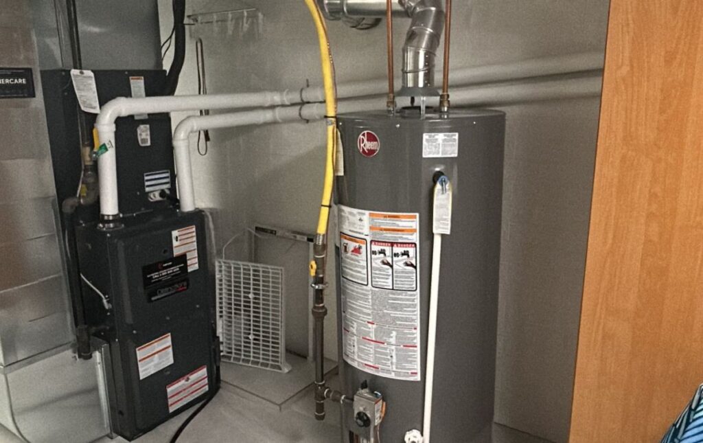 Superior Plumbing & Heating expert Water Heater Installation of a Rheem gas tank next to a residential HVAC system