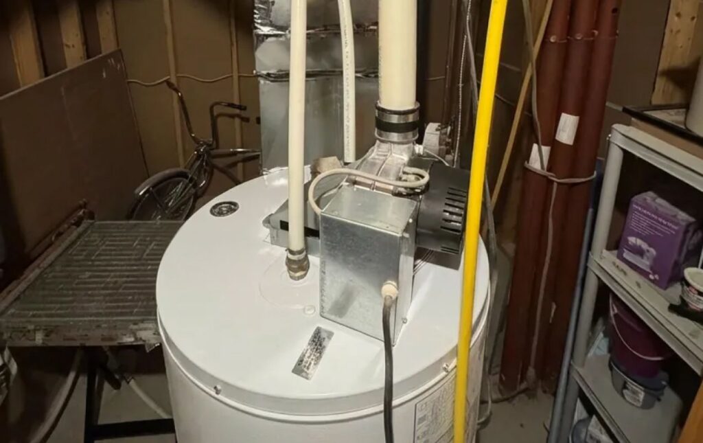 Superior Plumbing & Heating expert Water Heater Installation showing the power vent assembly on a white tank unit