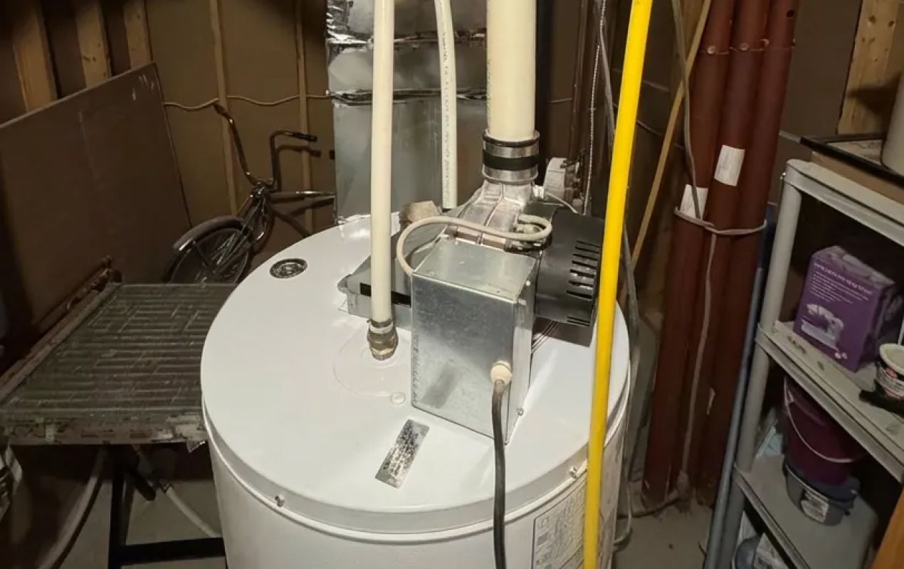 Superior Plumbing & Heating expert Water Heater Installation showing the power vent assembly on a white tank unit