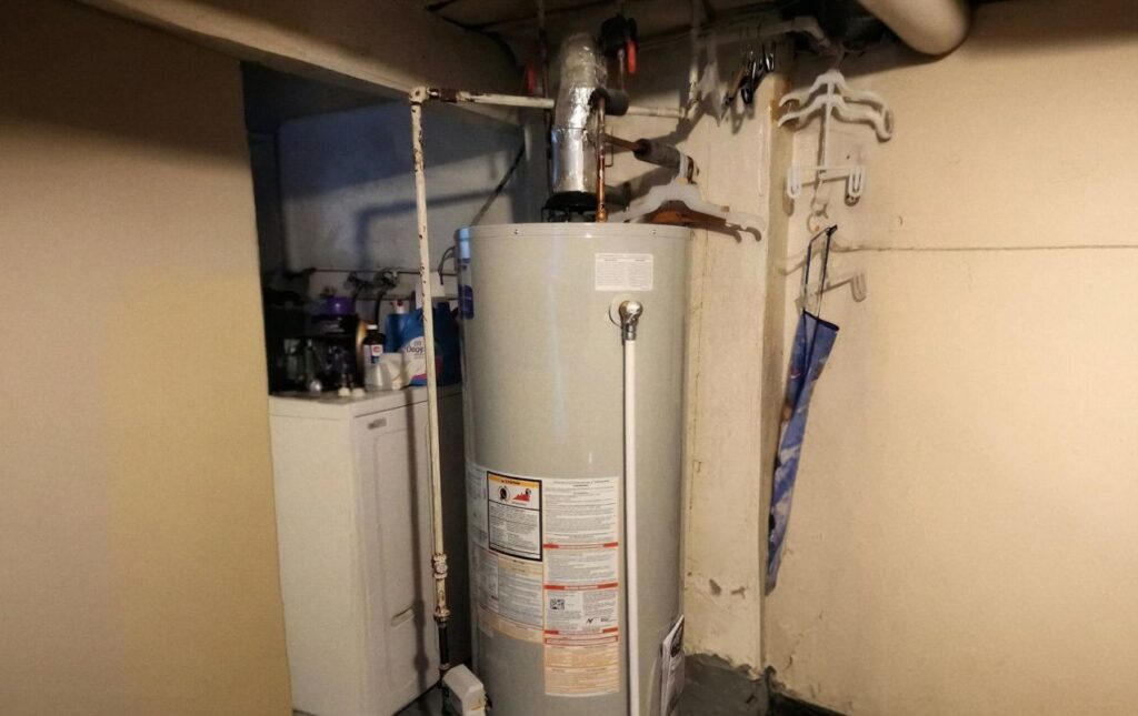 Superior Plumbing & Heating professional Water Heater Installation of a white storage tank in a residential basement