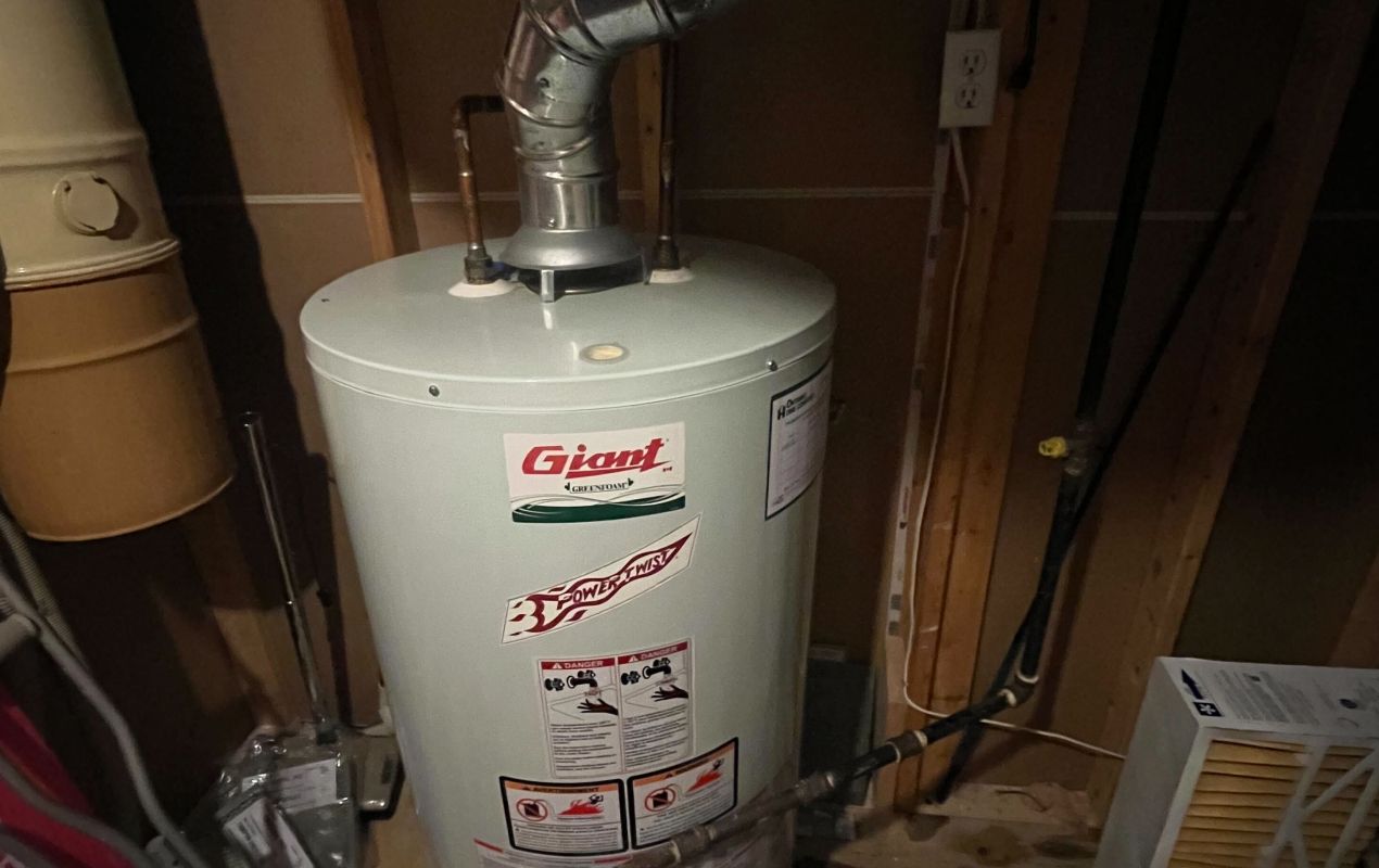 Superior Plumbing & Heating expert installing an GIant gas tank water heater with proper venting and safety controls in a home basement