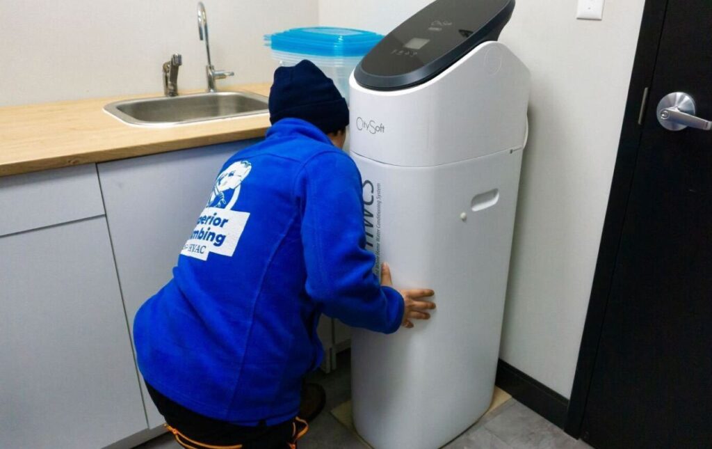 Superior Plumbing & Heating expert Water Softener Installation-replacement of a white CitySoft cabinet-style unit by a professional technician