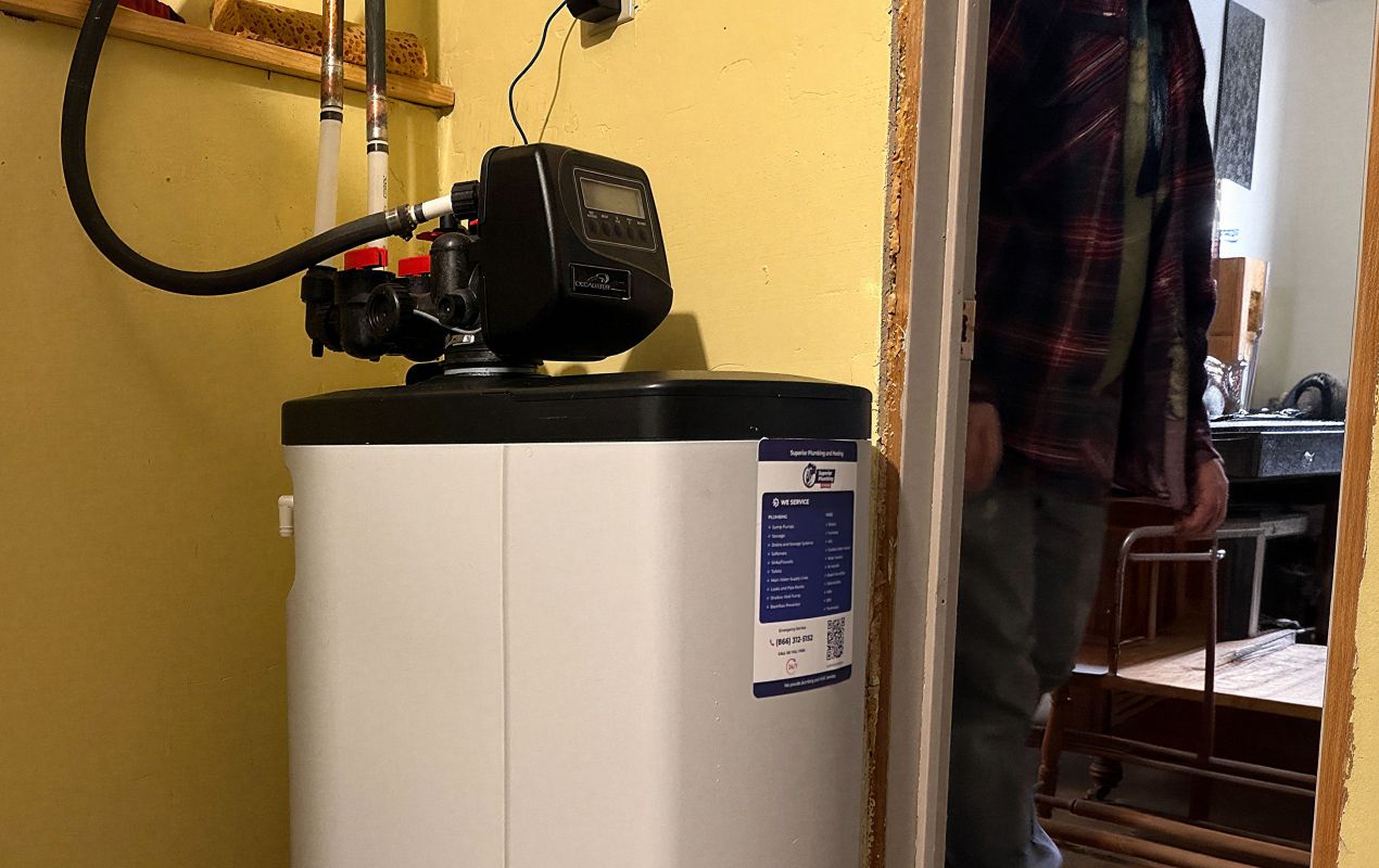 Superior Plumbing & Heating expert Water Softener Installation-replacement of a high-efficiency white and black cabinet water softener