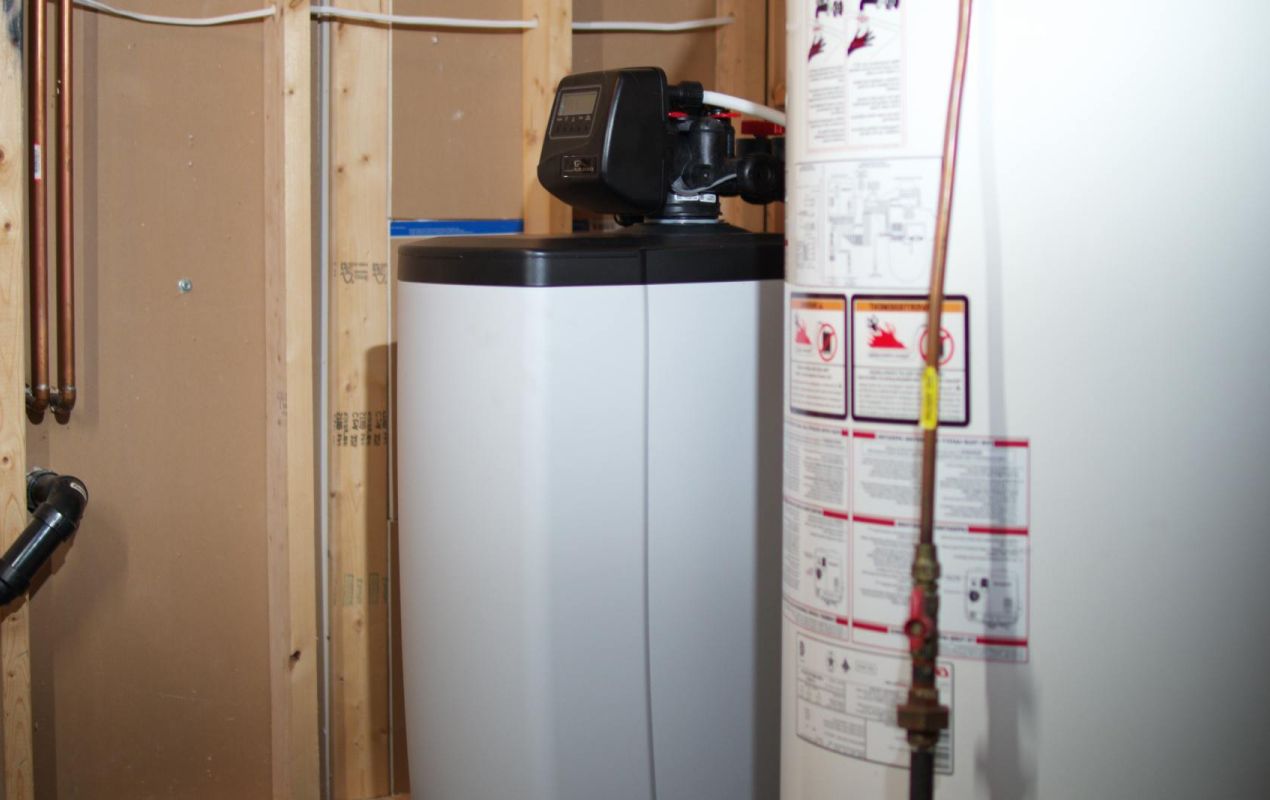 Superior Plumbing & Heating expert Water Softener Installation of a grey cabinet-style system next to a water heater