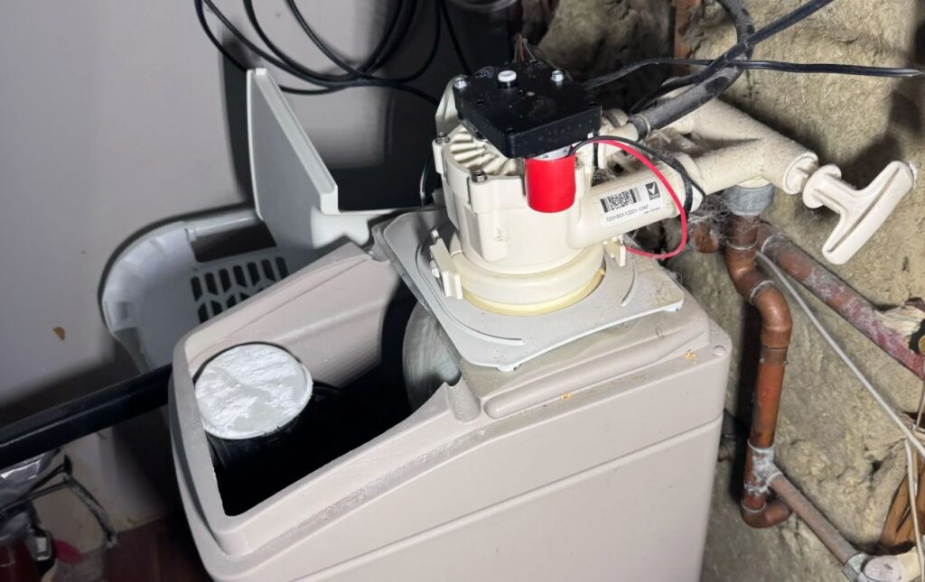 Superior Plumbing & Heating expert Water Softener Repair showing the internal mechanical valve components of a cabinet-style unit