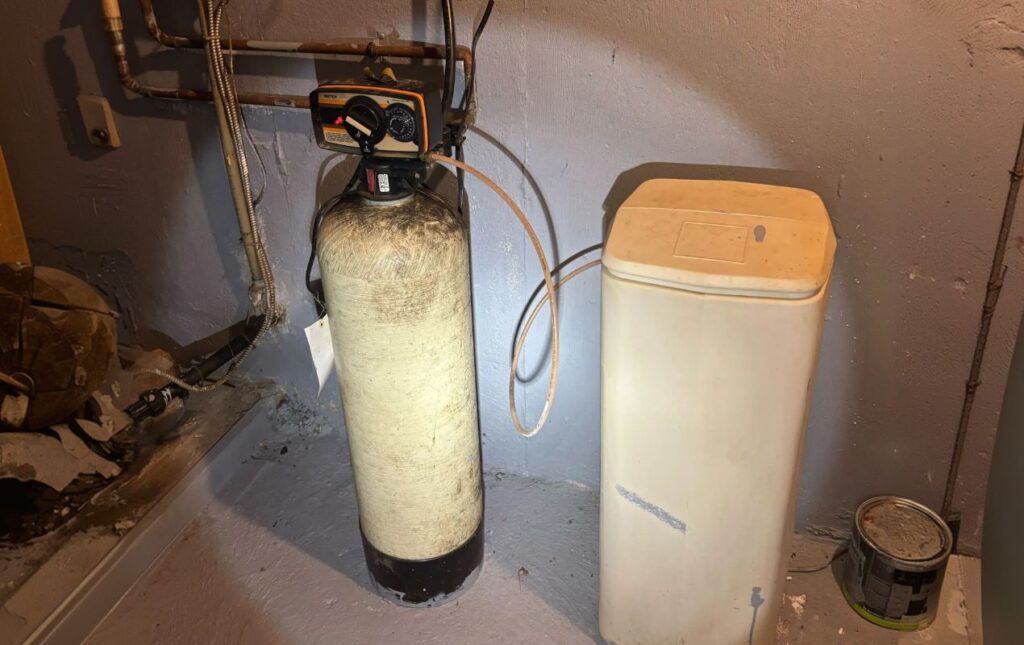 Superior Plumbing & Heating expert Water Softener Repair of a tan twin-tank resin system in a basement utility room