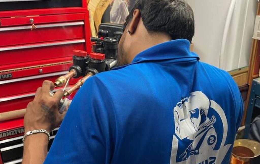 Superior Plumbing & Heating professional technician performing expert Water Softener Repair on plumbing connections