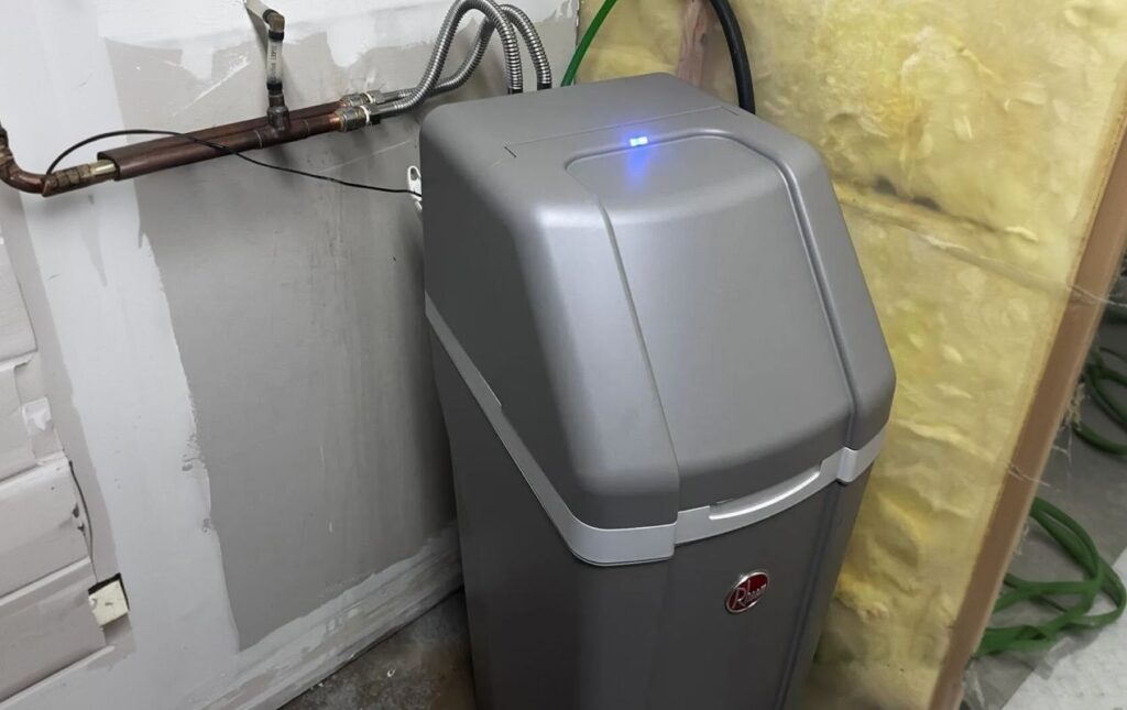 Superior Plumbing & Heating expert Water Softener Repair of a grey cabinet water softener in a residential basement