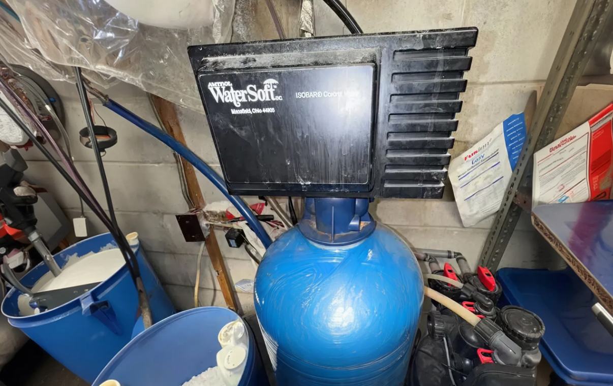 Superior Plumbing & Heating expert Water Softener Repair of a blue resin tank with a WaterSoft control head in a basement