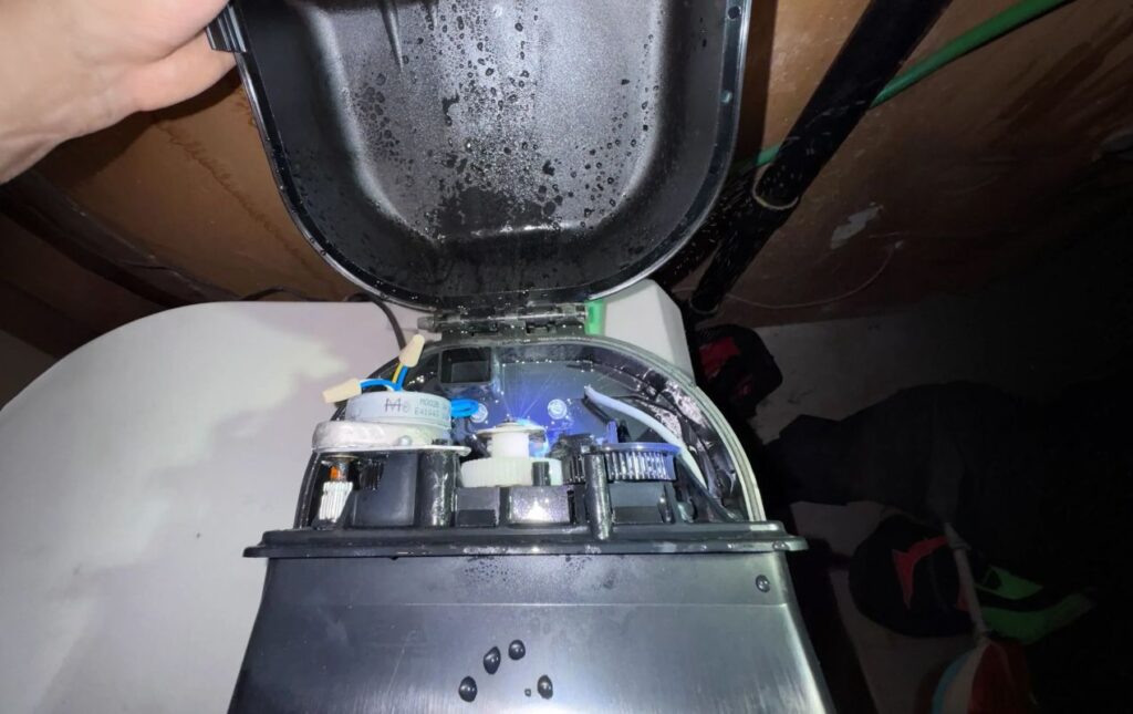 Superior Plumbing & Heating expert Water Softener Repair of an open control head showing internal mechanical gears