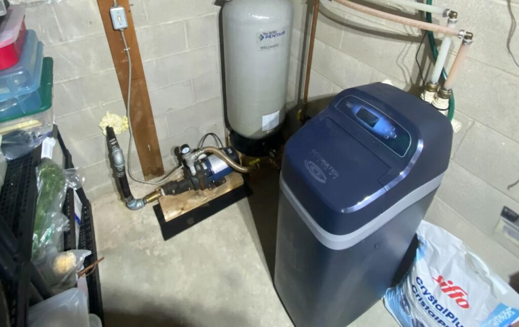 Superior Plumbing & Heating expert Water Softener Repair of a blue cabinet unit next to a residential pump system