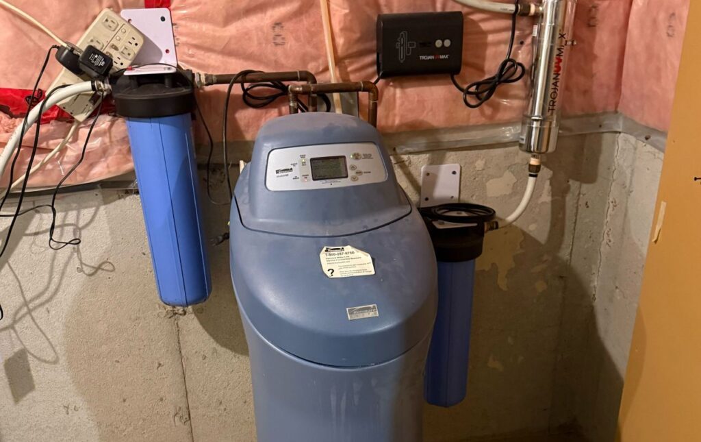 Superior Plumbing & Heating expert Water Softener Repair of a blue cabinet-style system with a whole-house filter housing