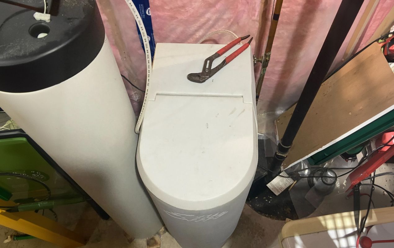 Superior Plumbing & Heating expert Water Softener Repair service featuring troubleshooting of a white residential cabinet unit