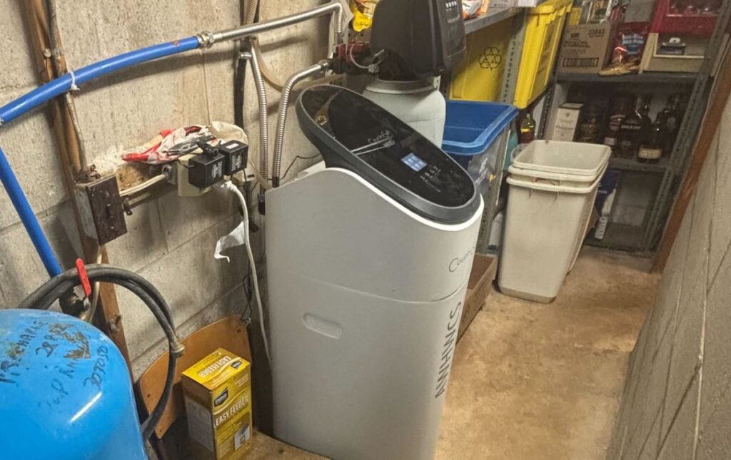 Superior Plumbing & Heating expert Water Softener Repair of a white high-efficiency cabinet-style unit in a residential utility area