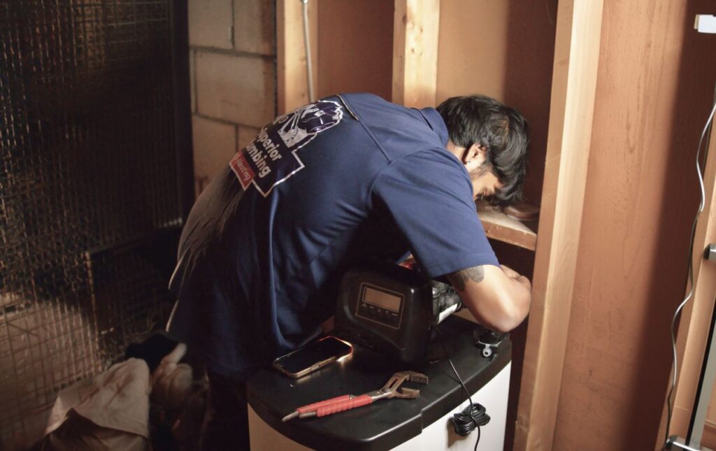 Superior Plumbing & Heating expert Water Softener Repair of a cabinet-style unit performed by a professional technician in a basement