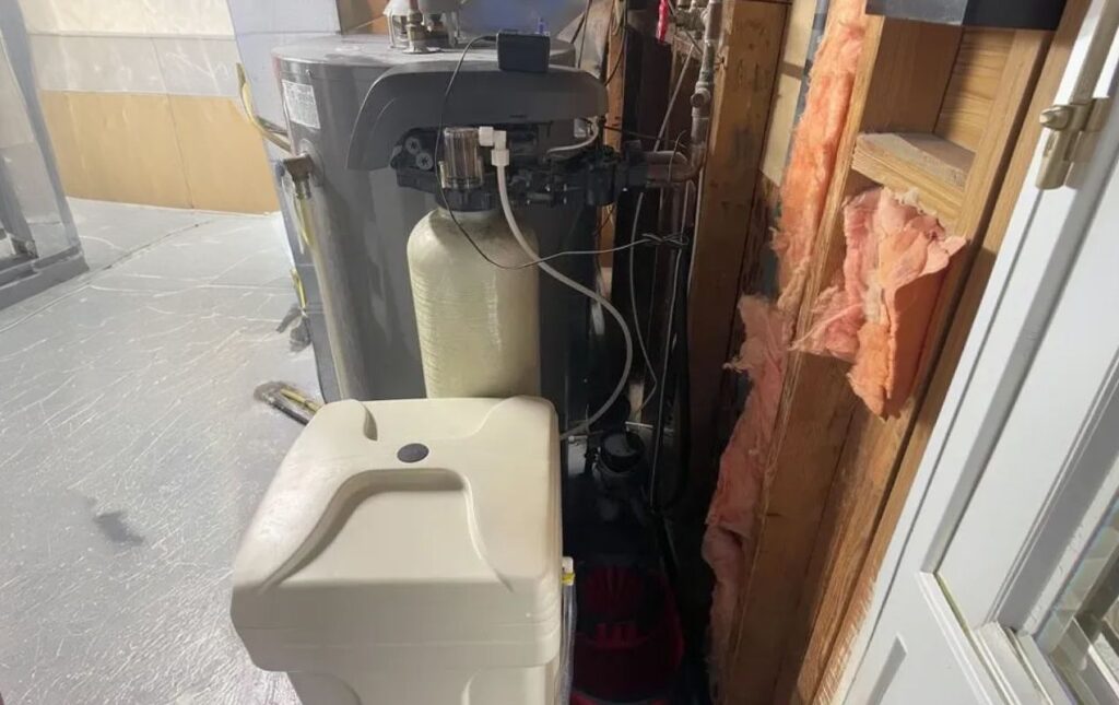 Superior Plumbing & Heating expert Water Softener Installation-replacement of a white brine tank and tan resin tank system in a basement