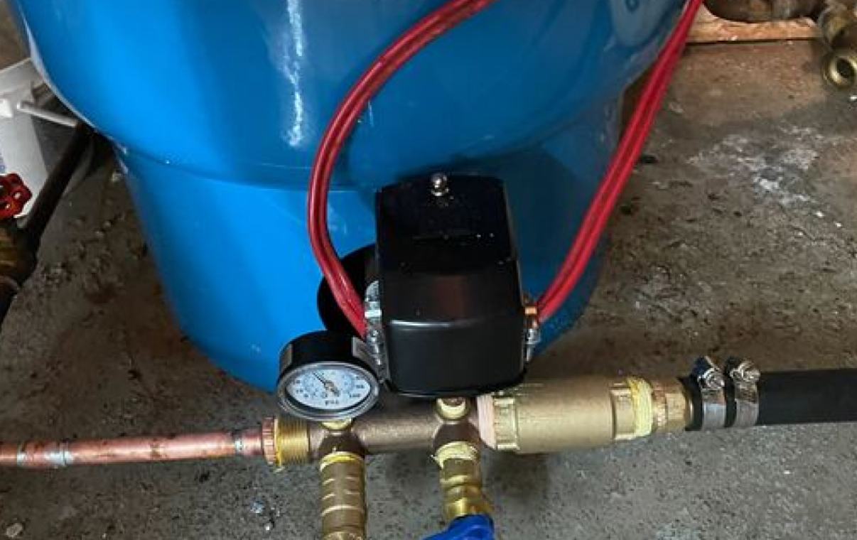 Close-up of pressure switch and gauge components used during a well pump installation local by Superior Plumbing & Heating