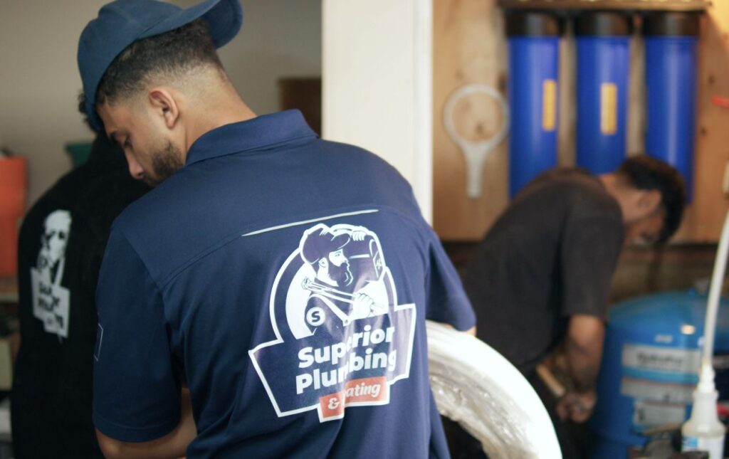 Superior Plumbing & Heating specialist carrying equipment for a residential well pump installation local project