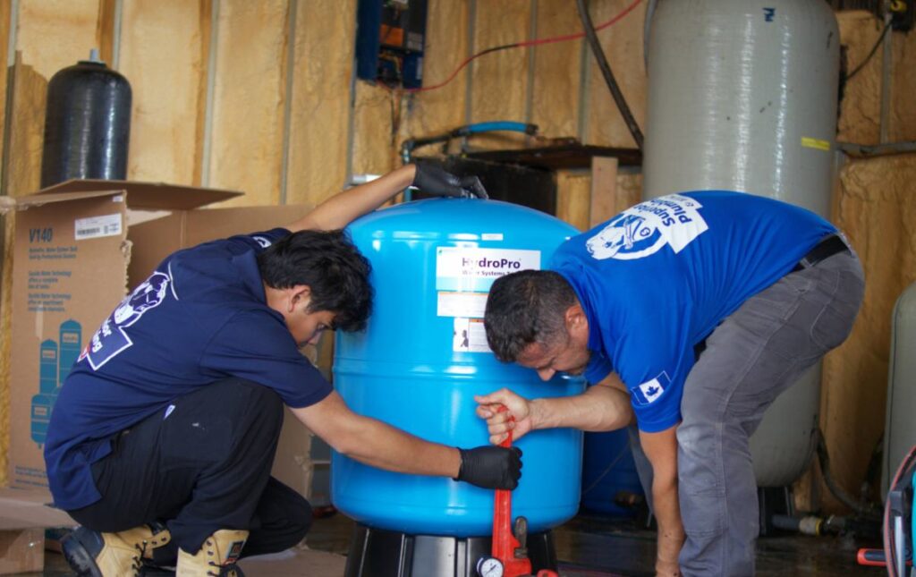 Licensed plumber from Superior Plumbing & Heating inspecting the basement area for a well pump installation local