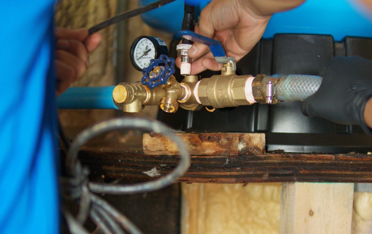 Close-up of brass manifold, valves, and gauge used in a well pump installation local by Superior Plumbing & Heating